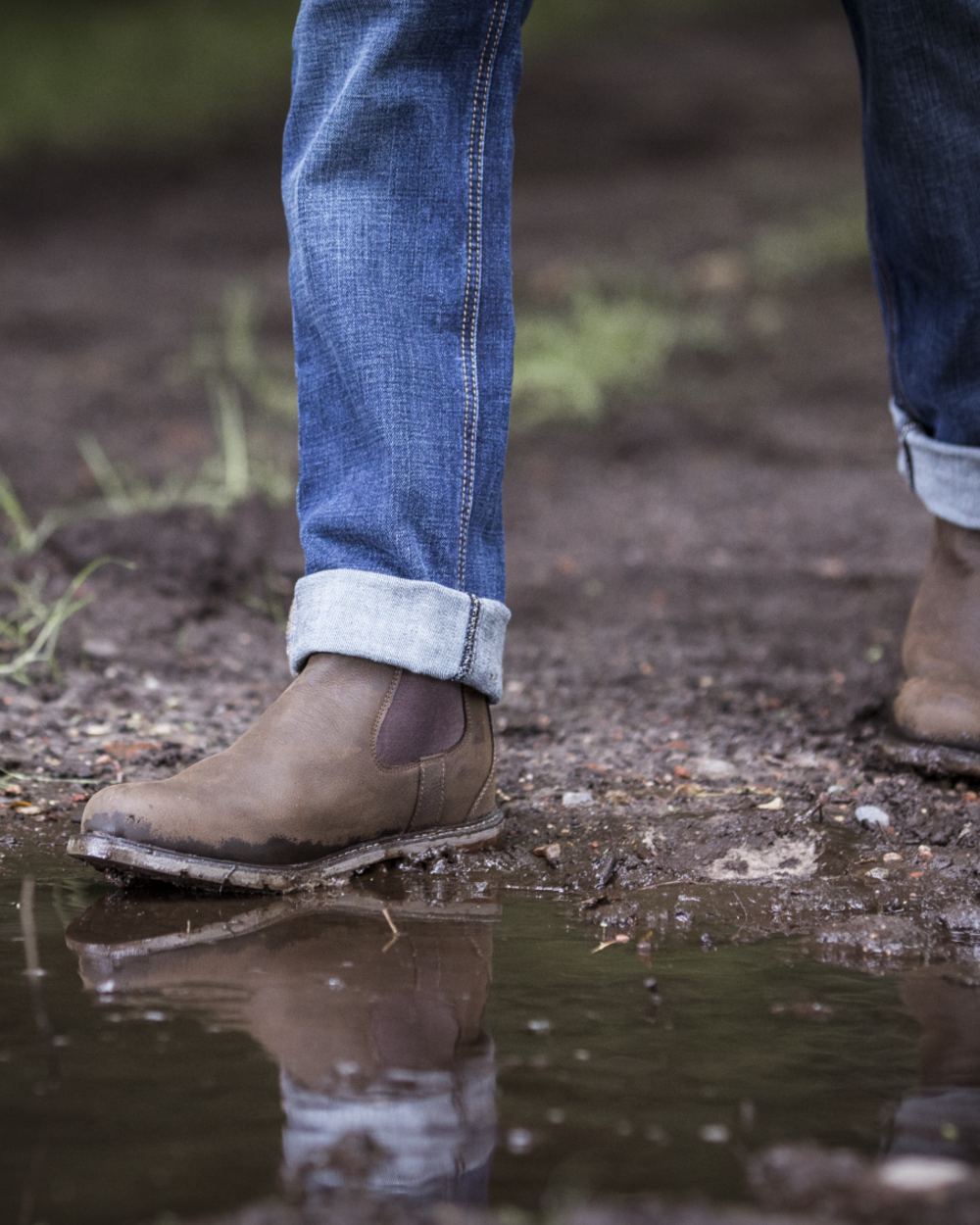 Java coloured Ariat Wexford Waterproof Boots on mud background 