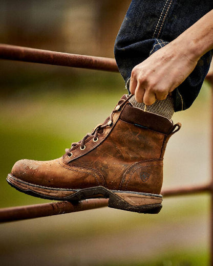 Distressed Brown Coloured Ariat Womens Anthem Round Toe Lacer Waterproof Boot on blurry background 