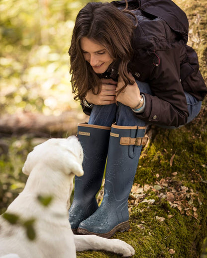 Navy coloured Ariat Womens Burford Wellington Boots on forest background 