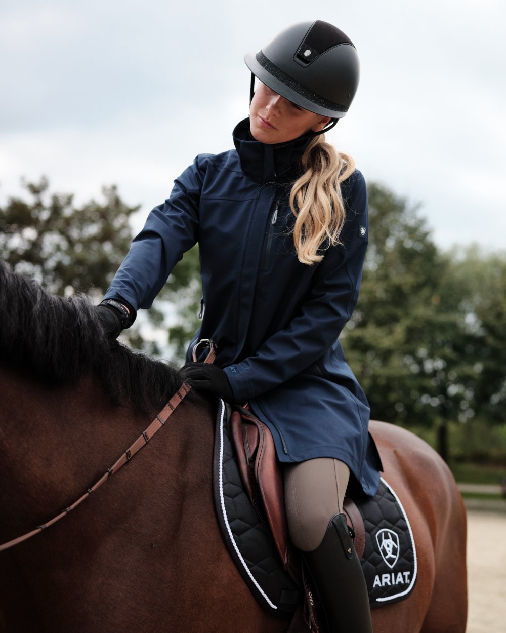 Navy Eclipse Coloured Ariat Womens Coastal Long Waterproof Parka on outdoor background 