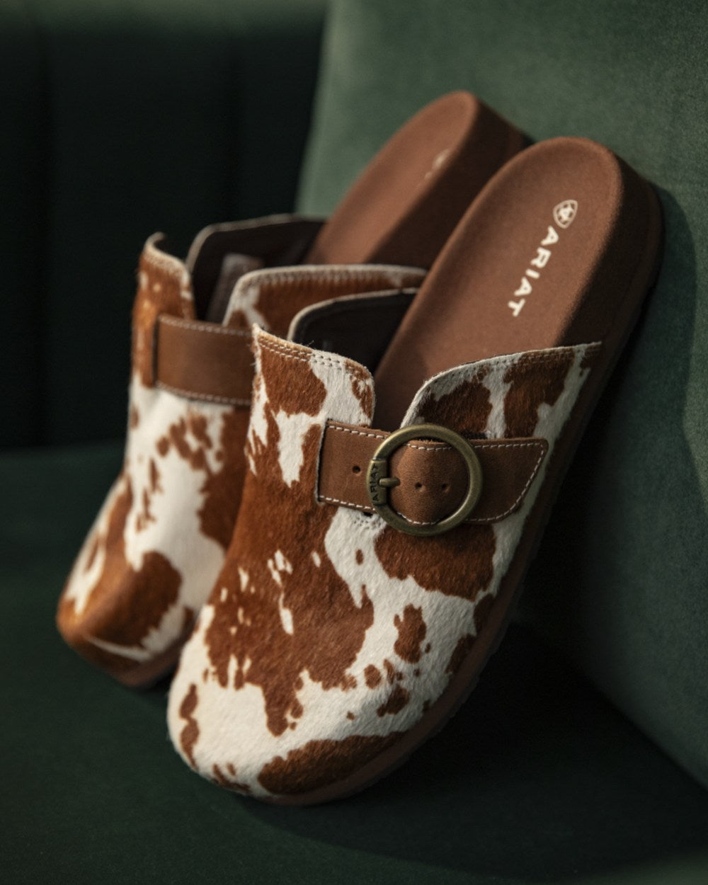 Cow Hair On coloured Ariat Womens Country Mules on indoor background 