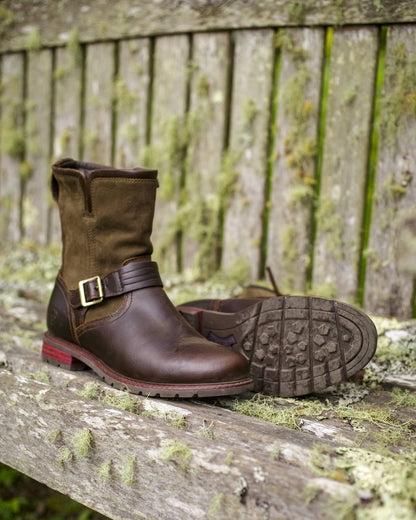 Chocolate Coloured Ariat Womens Savannah Waterproof Boots on wood wall background 