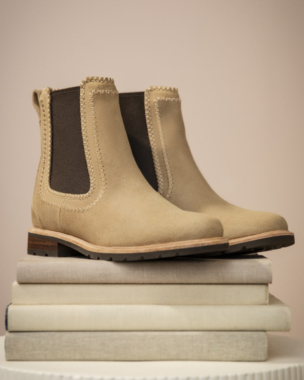 Camel Suede coloured Ariat Womens Wexford Whipstitch Chelsea Boots on indoor background 