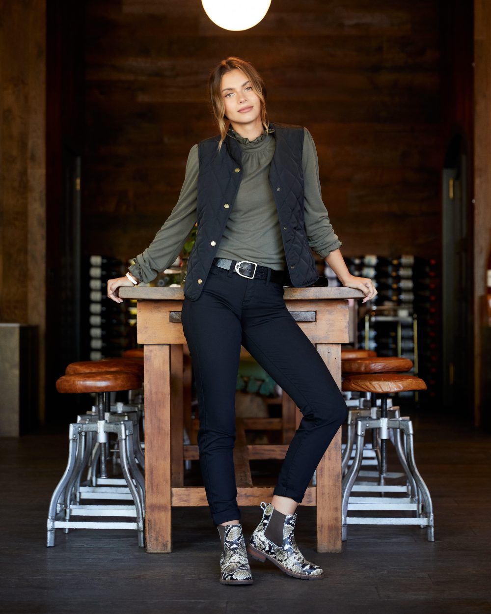 Black Coloured Ariat Womens Woodside Quilted Gilet on bar table background 