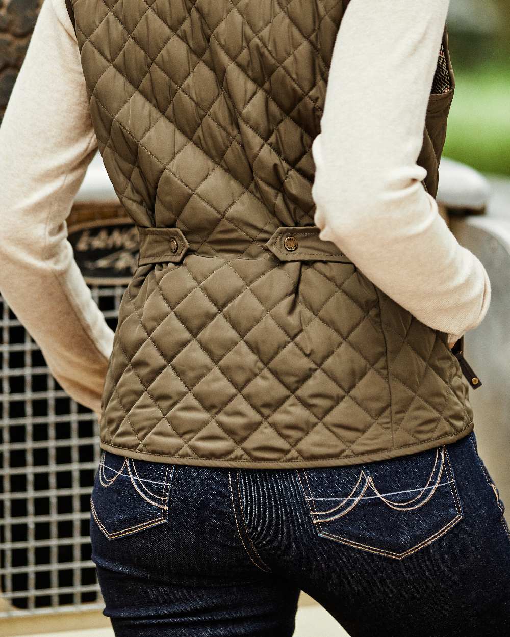 Earth Coloured Ariat Womens Woodside Quilted Gilet on car background 