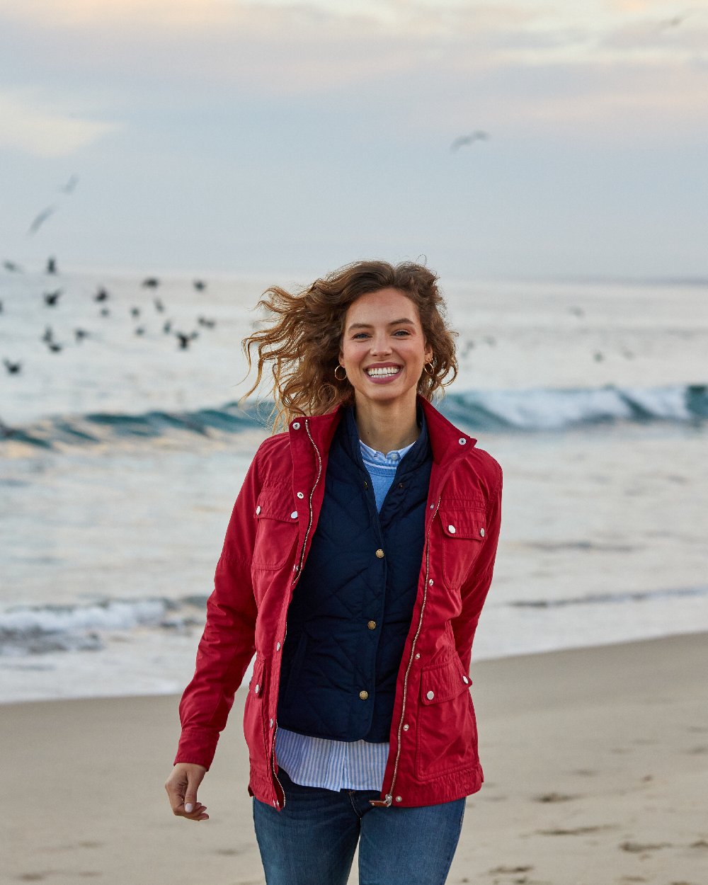 Navy Coloured Ariat Womens Woodside Quilted Gilet on sea background 