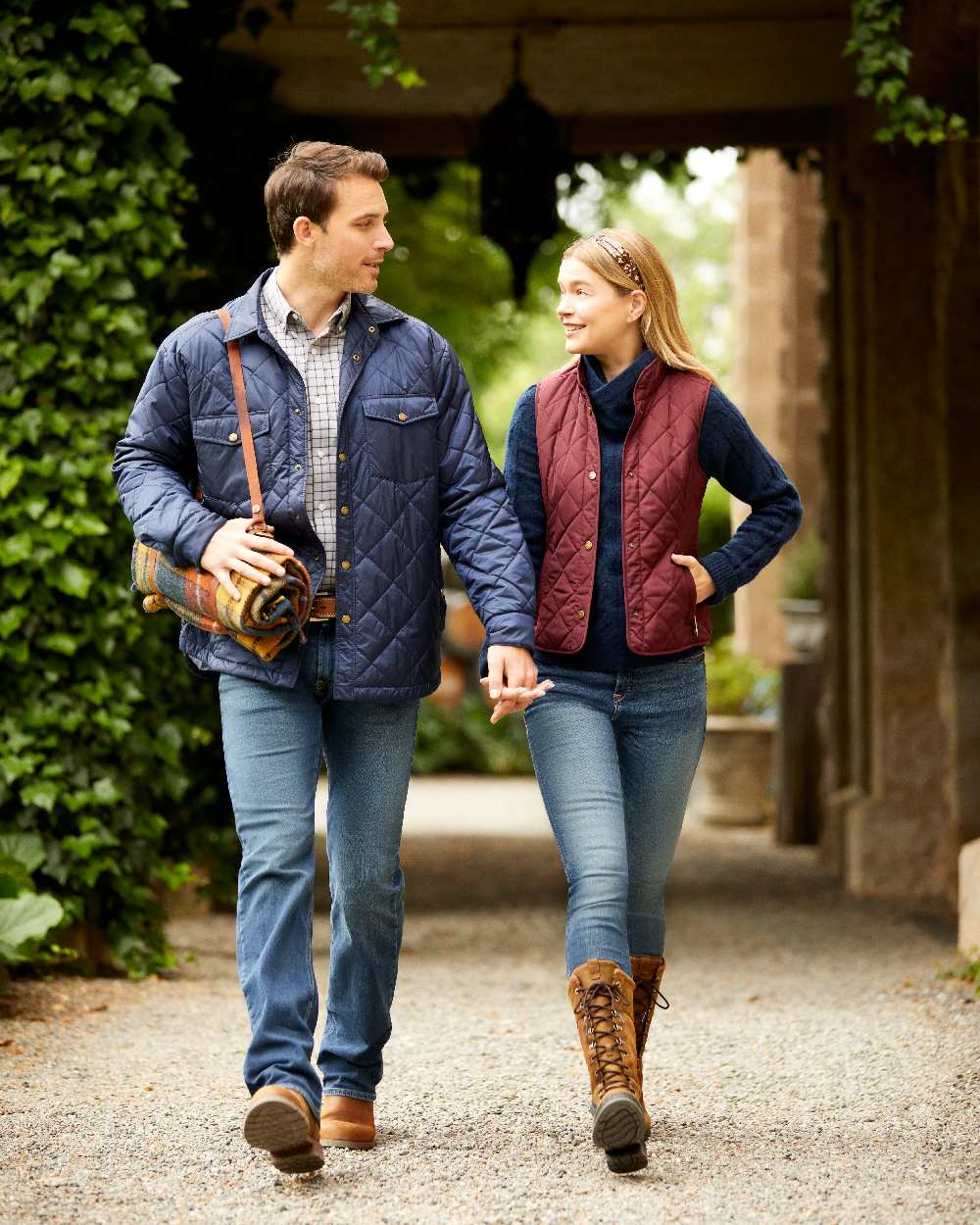Navy Coloured Ariat Womens Woodside Quilted Gilet on house background 