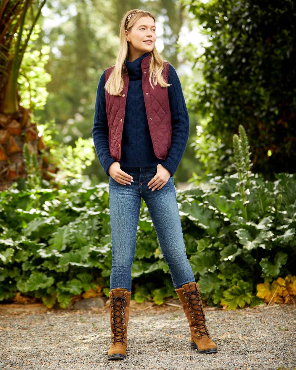 Tawny Port Coloured Ariat Womens Woodside Quilted Gilet on park background 