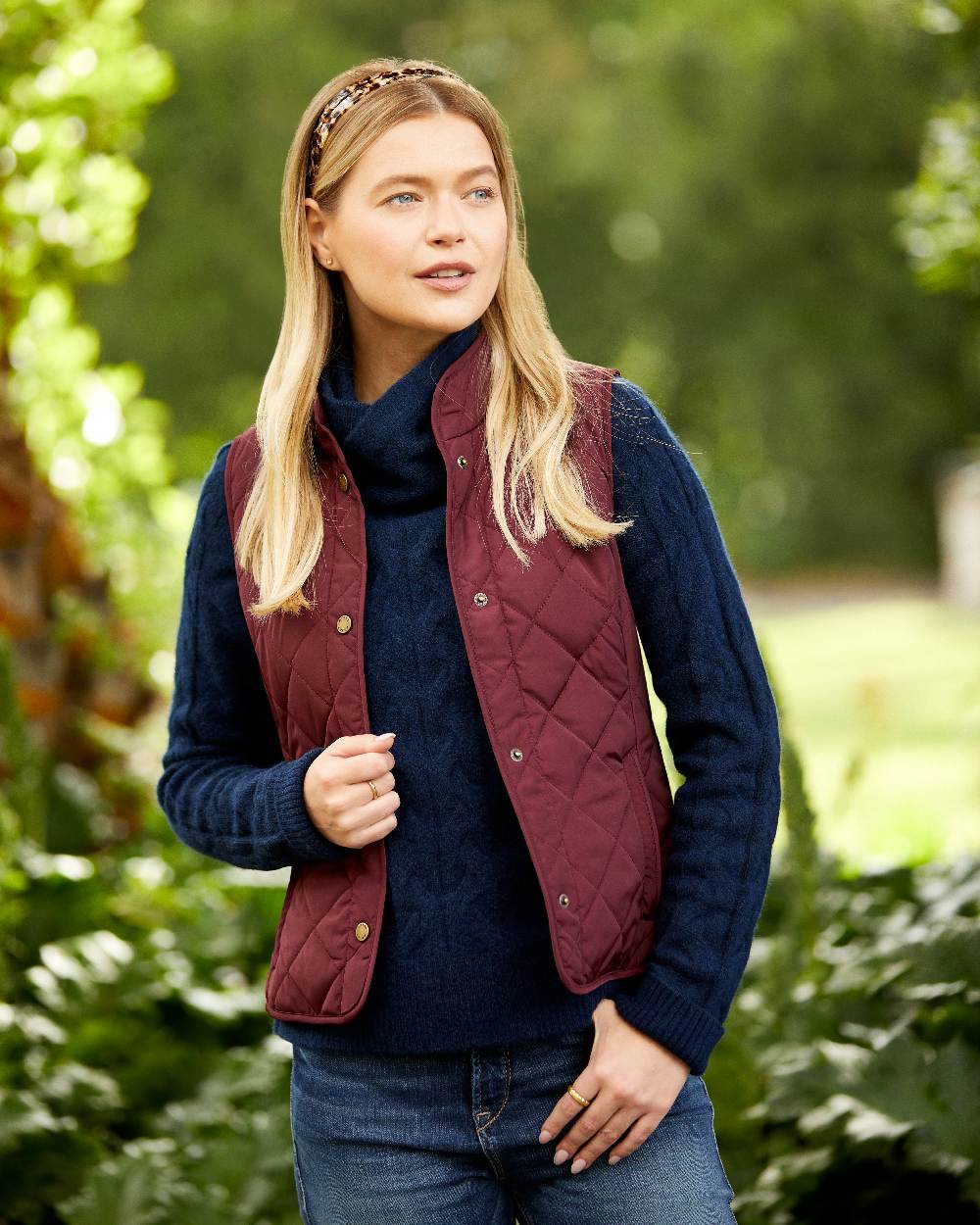 Tawny Port Coloured Ariat Womens Woodside Quilted Gilet on park background 