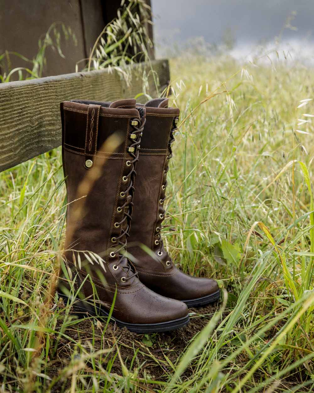 Tobacco Brown coloured Ariat Wythburn Waterproof Boots on field background 