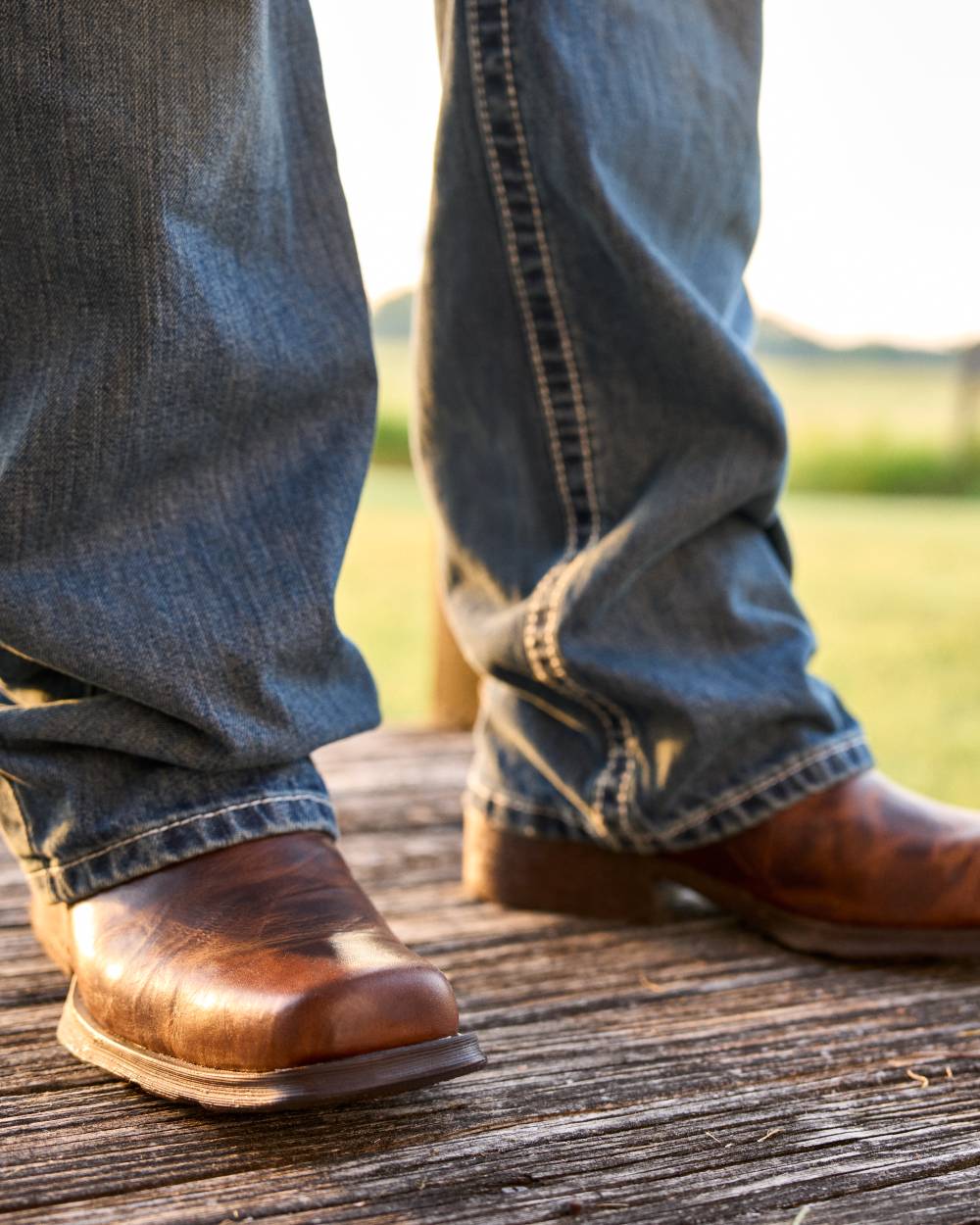 Barn Brown coloured Ariat Mens Midtown Rambler Western Boots on country background 