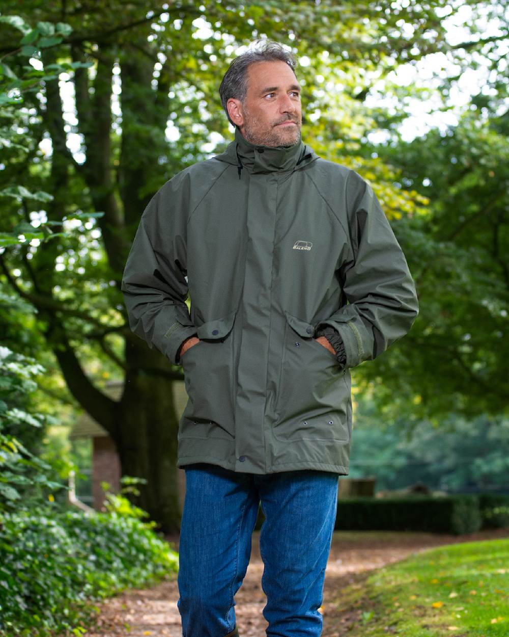 Khaki Coloured Baleno Arras Rain Jacket on forest background 