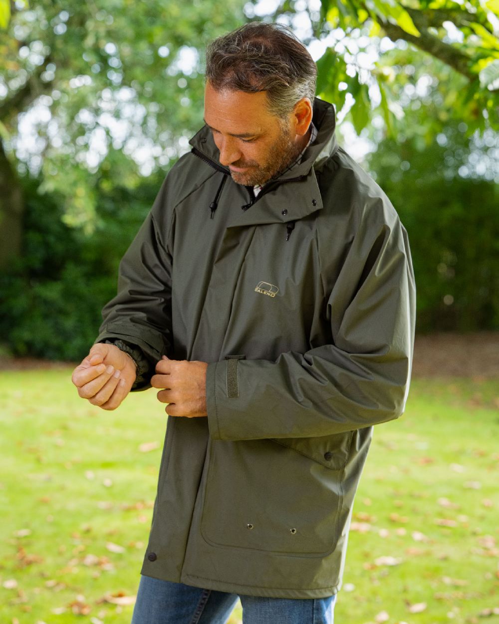 Khaki Coloured Baleno Arras Rain Jacket on forest background 