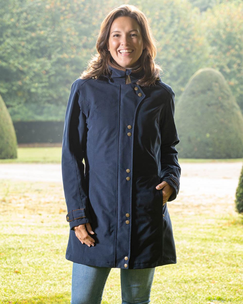 Dark Blue Coloured Baleno Brooklands Waterproof Coat on land background 