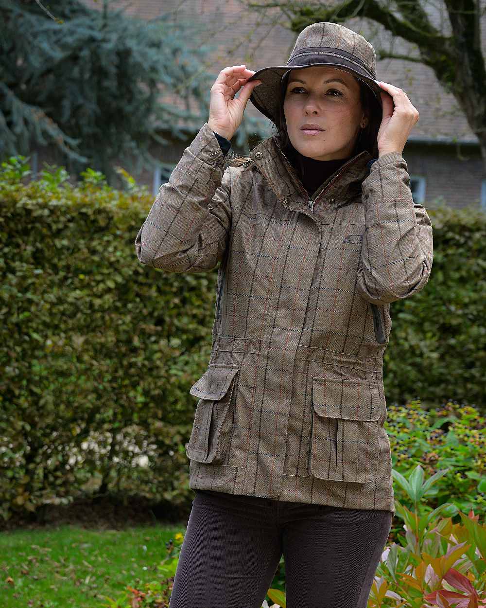 Check Khaki Coloured Baleno Caitlin Printed Tweed Hat on house background 