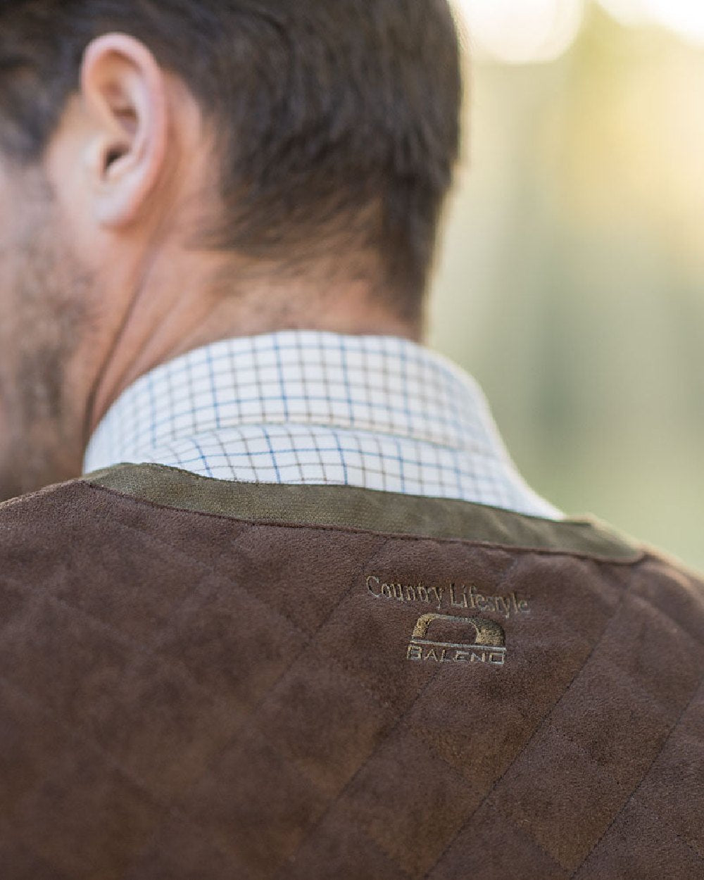 Pine Green Coloured Baleno Dolman Gilet on blurry background 