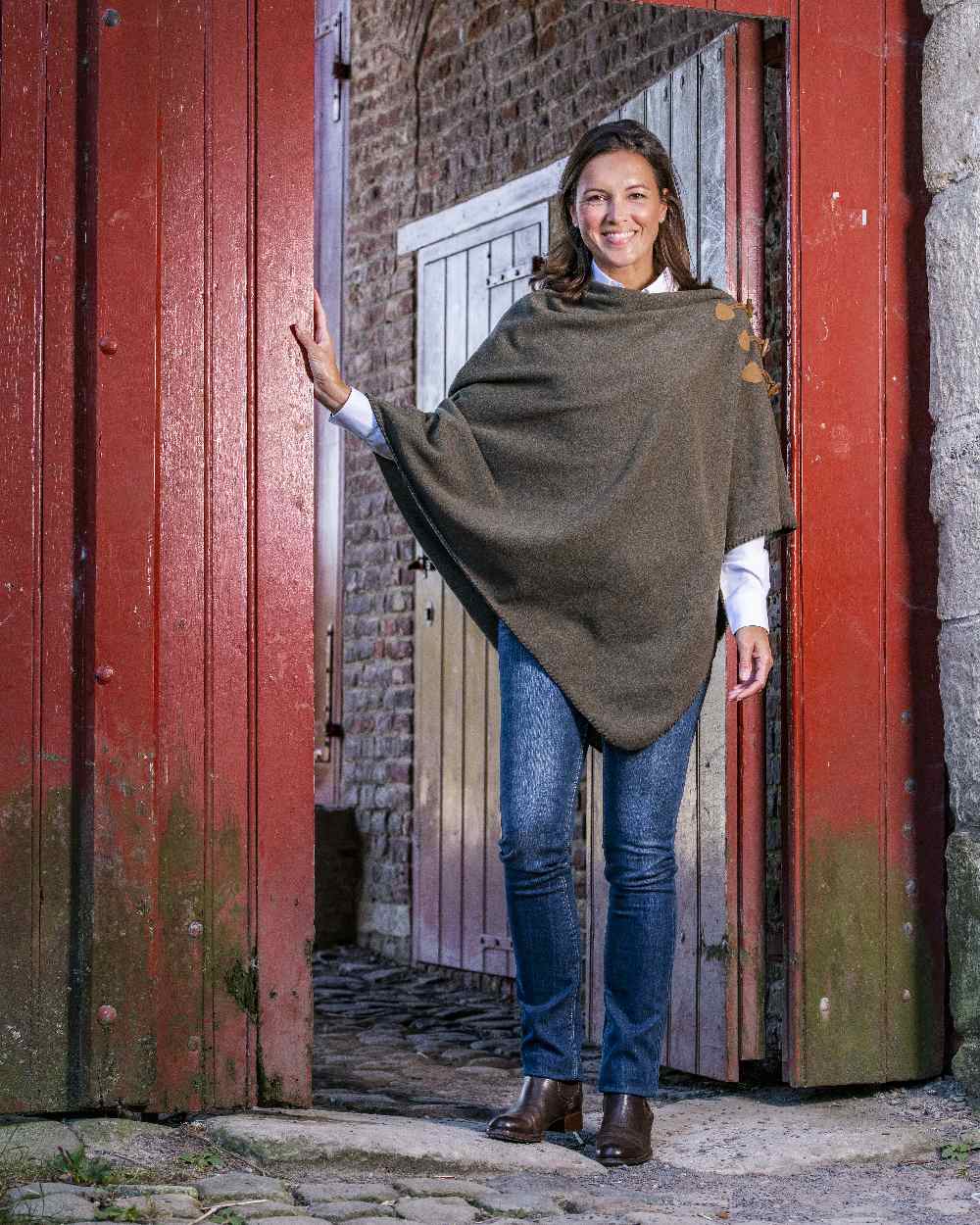 Moss Green Coloured Baleno Elite Fleece Poncho on door background 