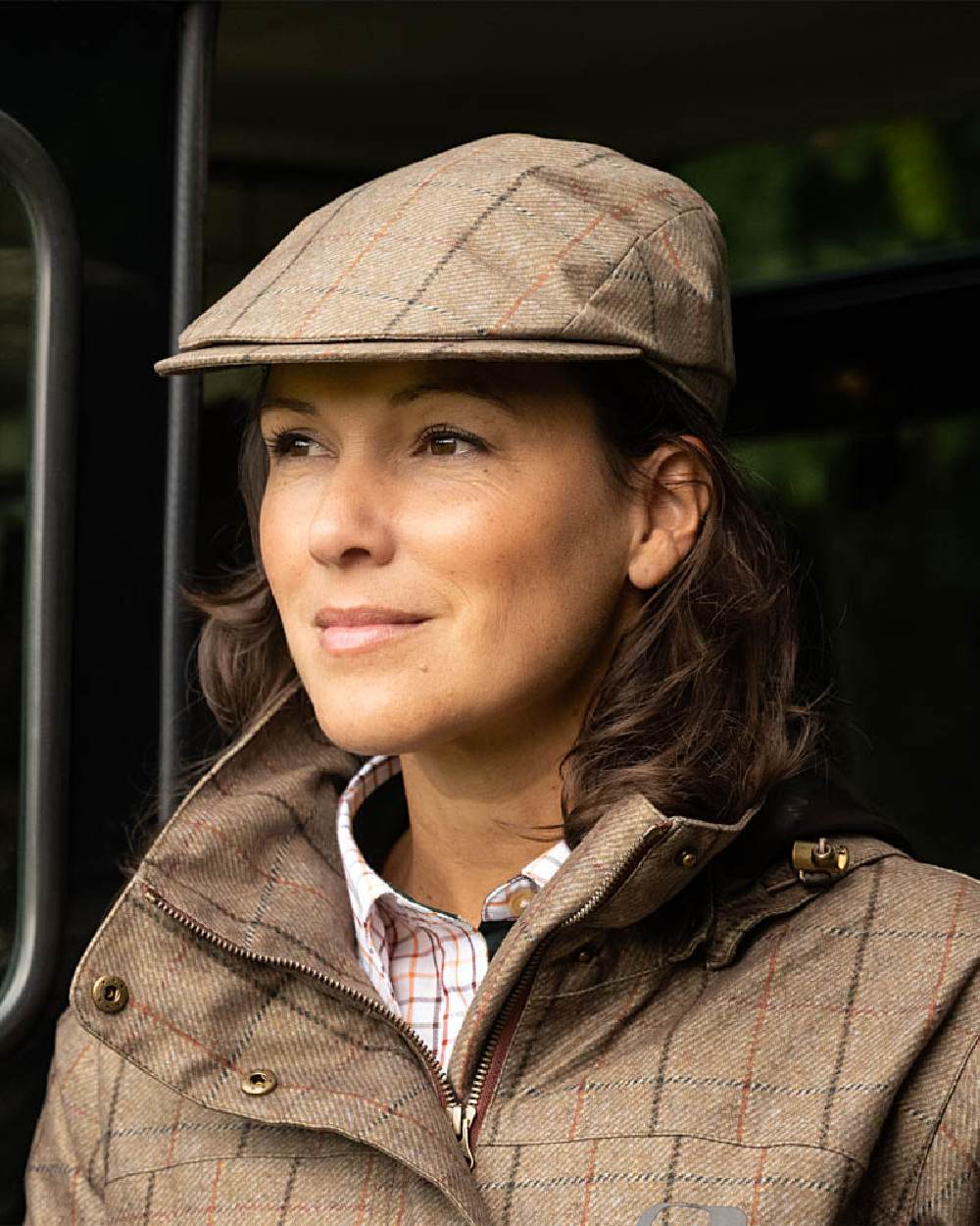 Check Khaki Baleno Foxton Tweed Cap on blurry background 