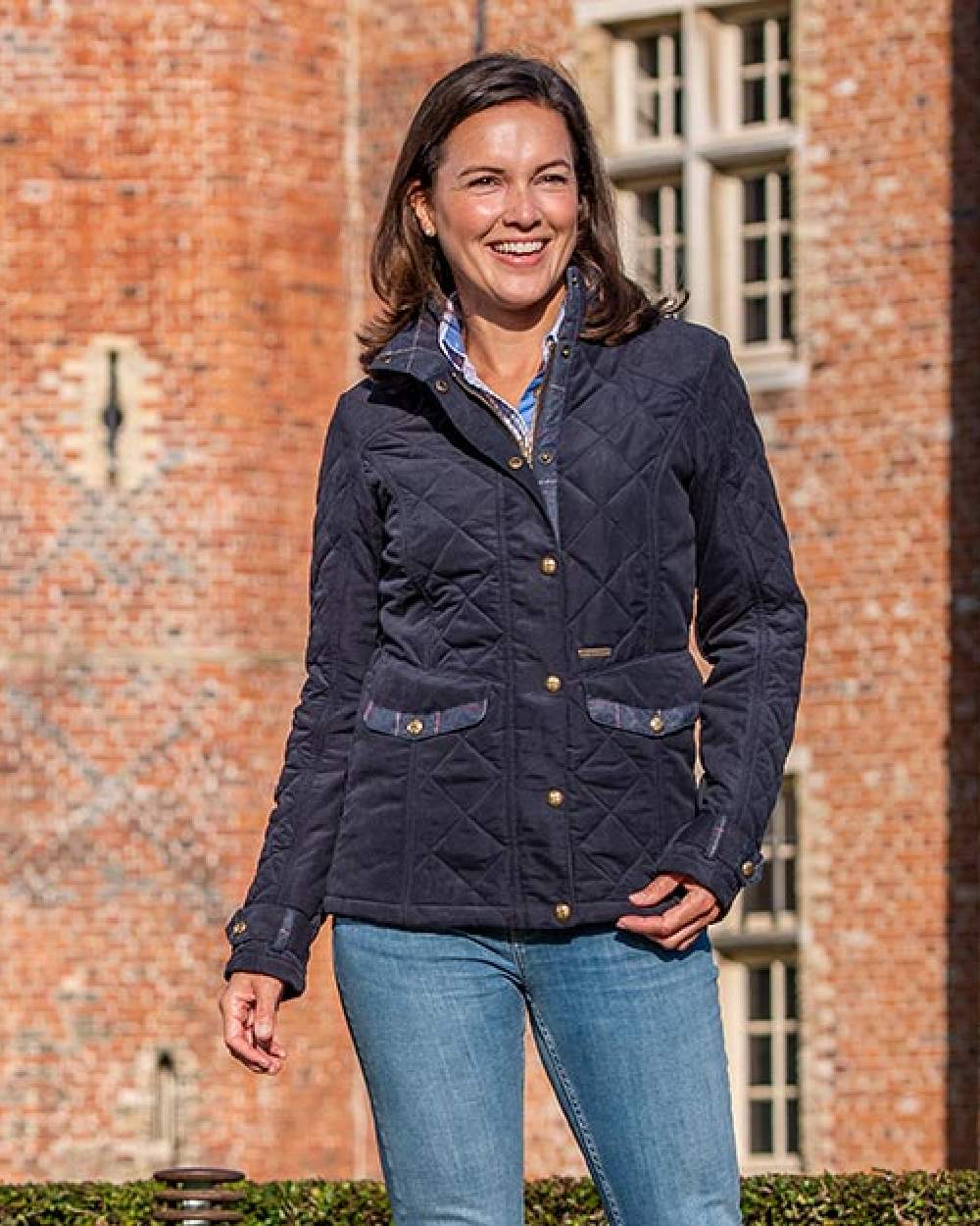 Dark Navy Blue Coloured Baleno Halifax Ladies Quilted Jacket on building background 