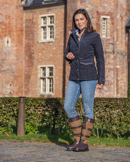 Dark Navy Blue Coloured Baleno Halifax Ladies Quilted Jacket on building background 