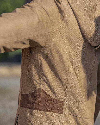 Camel Coloured Baleno Harmony Waterproof Coat on blurry background 