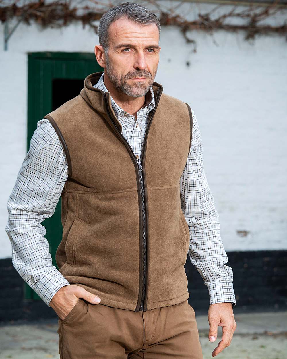 Camel Coloured Baleno Harvey Fleece Gilet on house background 