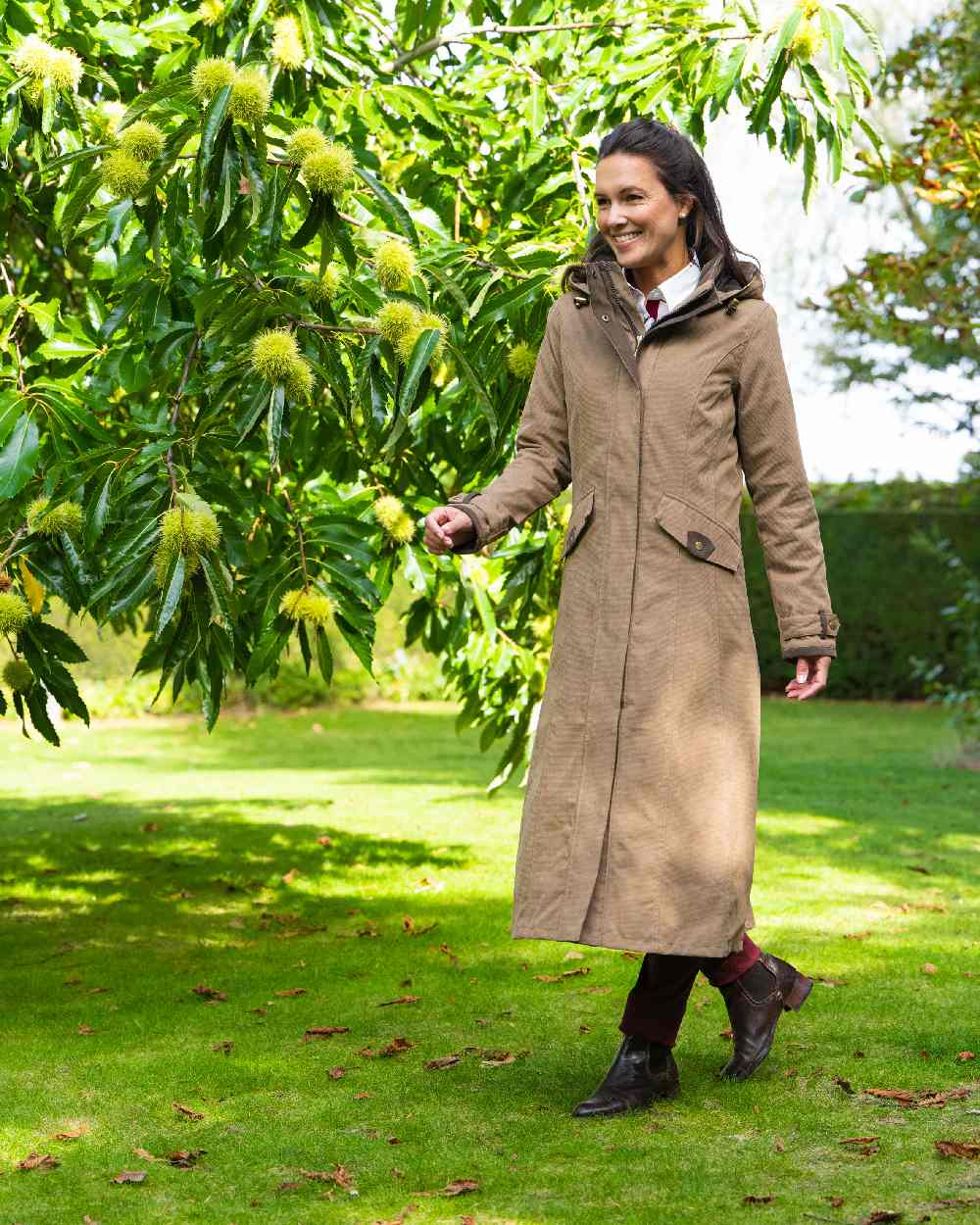 Camel Coloured Baleno Kensington Long Waterproof Coat on countryside background 