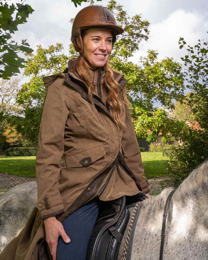 Camel Coloured Baleno Kensington Long Waterproof Coat on countryside background 