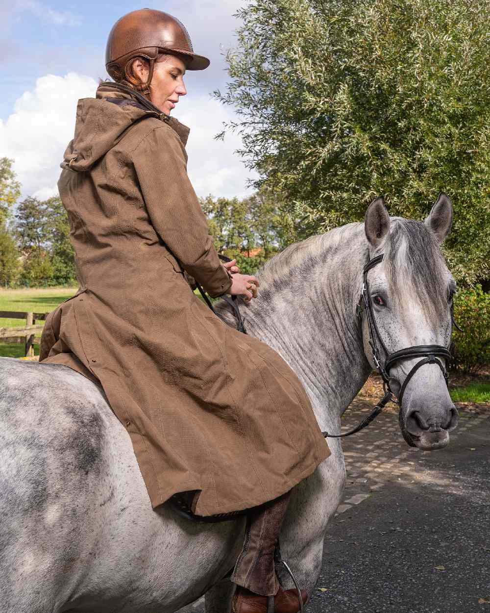 Camel Coloured Baleno Kensington Long Waterproof Coat on countryside background 