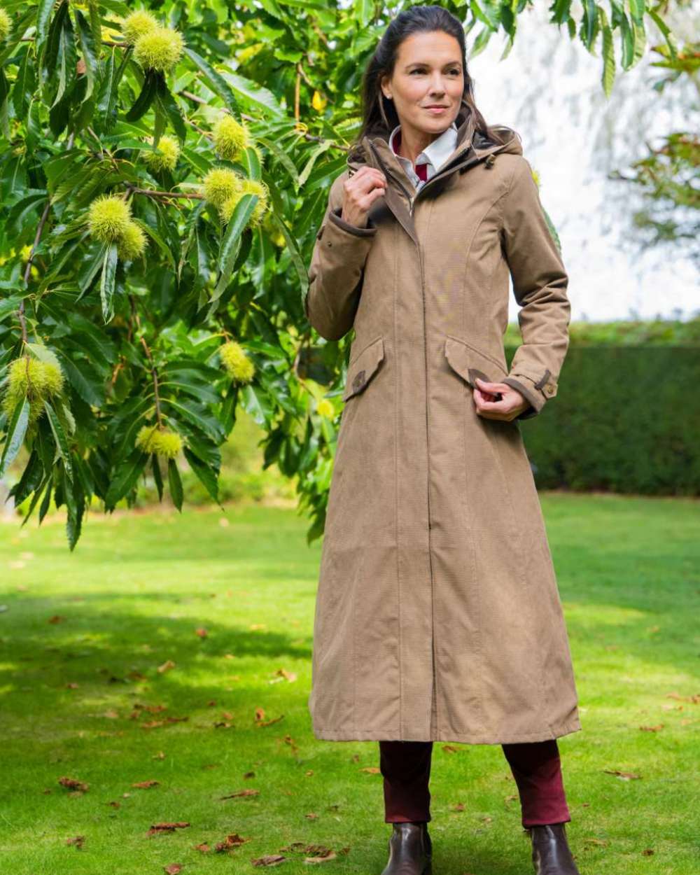 Camel Coloured Baleno Kensington Long Waterproof Coat on countryside background 