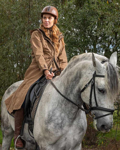 Camel Coloured Baleno Kensington Long Waterproof Coat on countryside background 