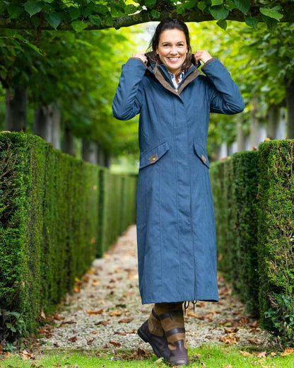 Navy Blue Coloured Baleno Kensington Long Waterproof Coat on countryside background 