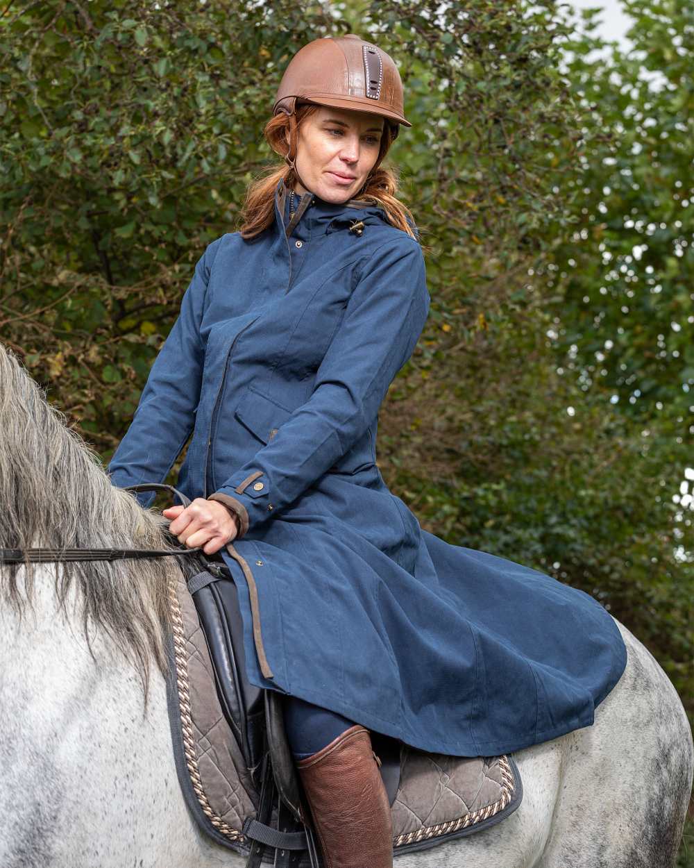 Navy Blue Coloured Baleno Kensington Long Waterproof Coat on countryside background 