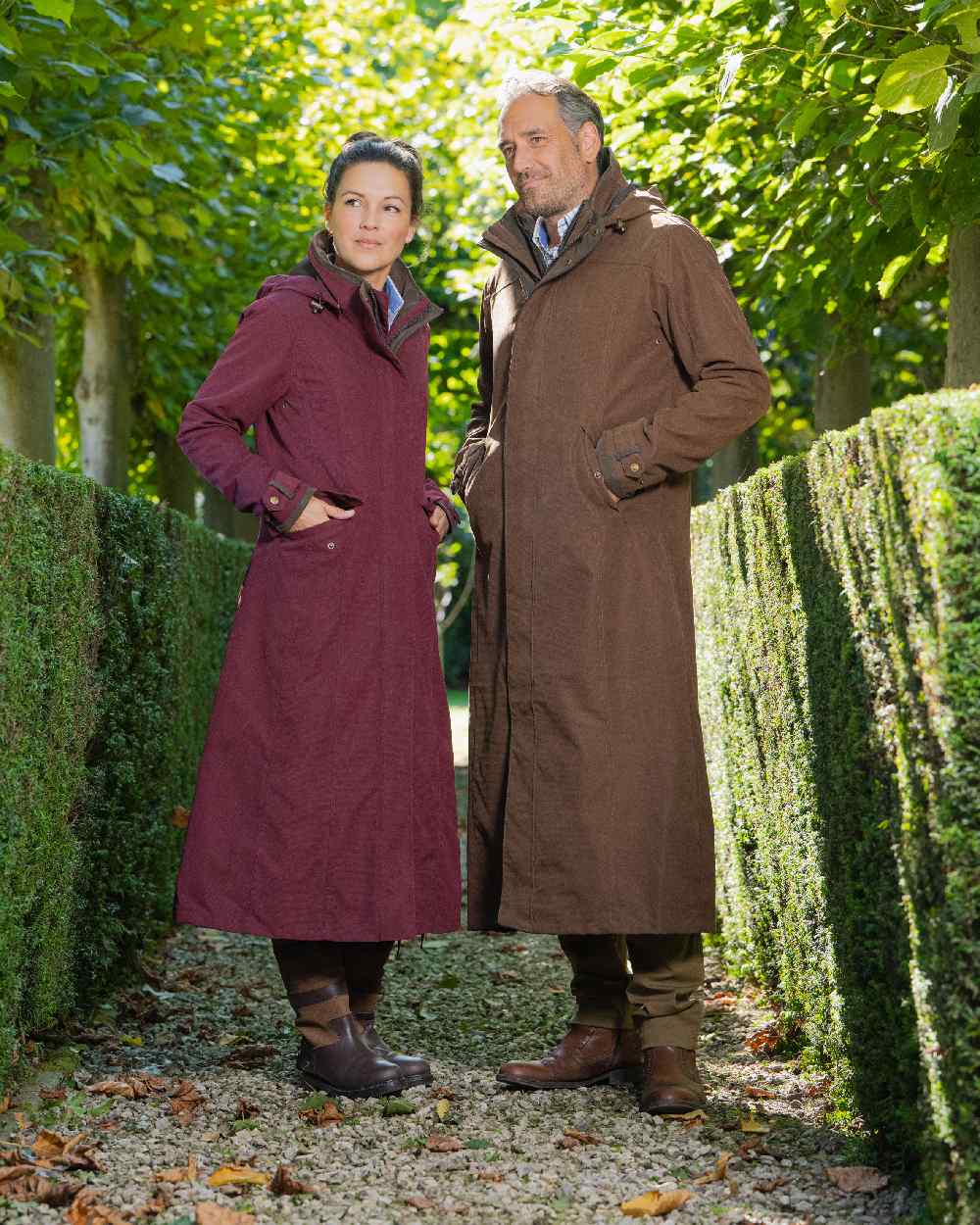 Raspberry Coloured Baleno Kensington Long Waterproof Coat on countryside background 