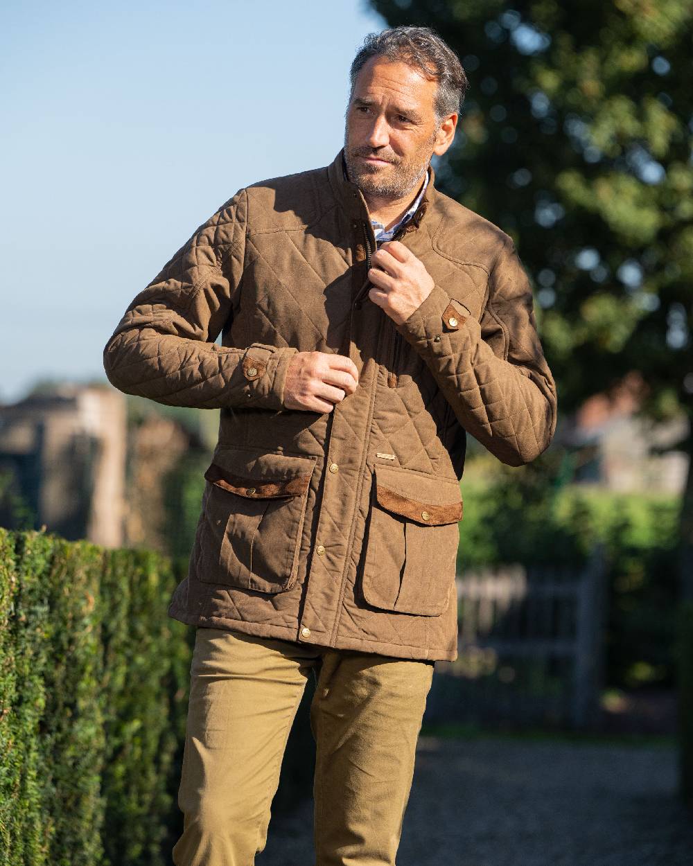 Earth Brown coloured Baleno Mens Goodwood Quilted Jacket on blurry background 