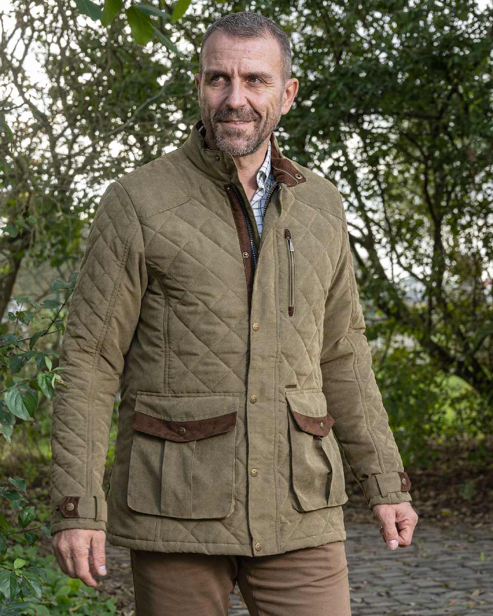 Light Khaki coloured Baleno Mens Goodwood Quilted Jacket on countryside background 