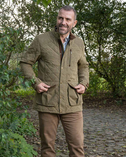 Light Khaki coloured Baleno Mens Goodwood Quilted Jacket on countryside background 