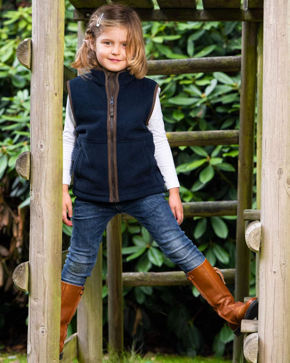 Navy Blue coloured Baleno Wizz Kids Fleece Gilet on forest background 