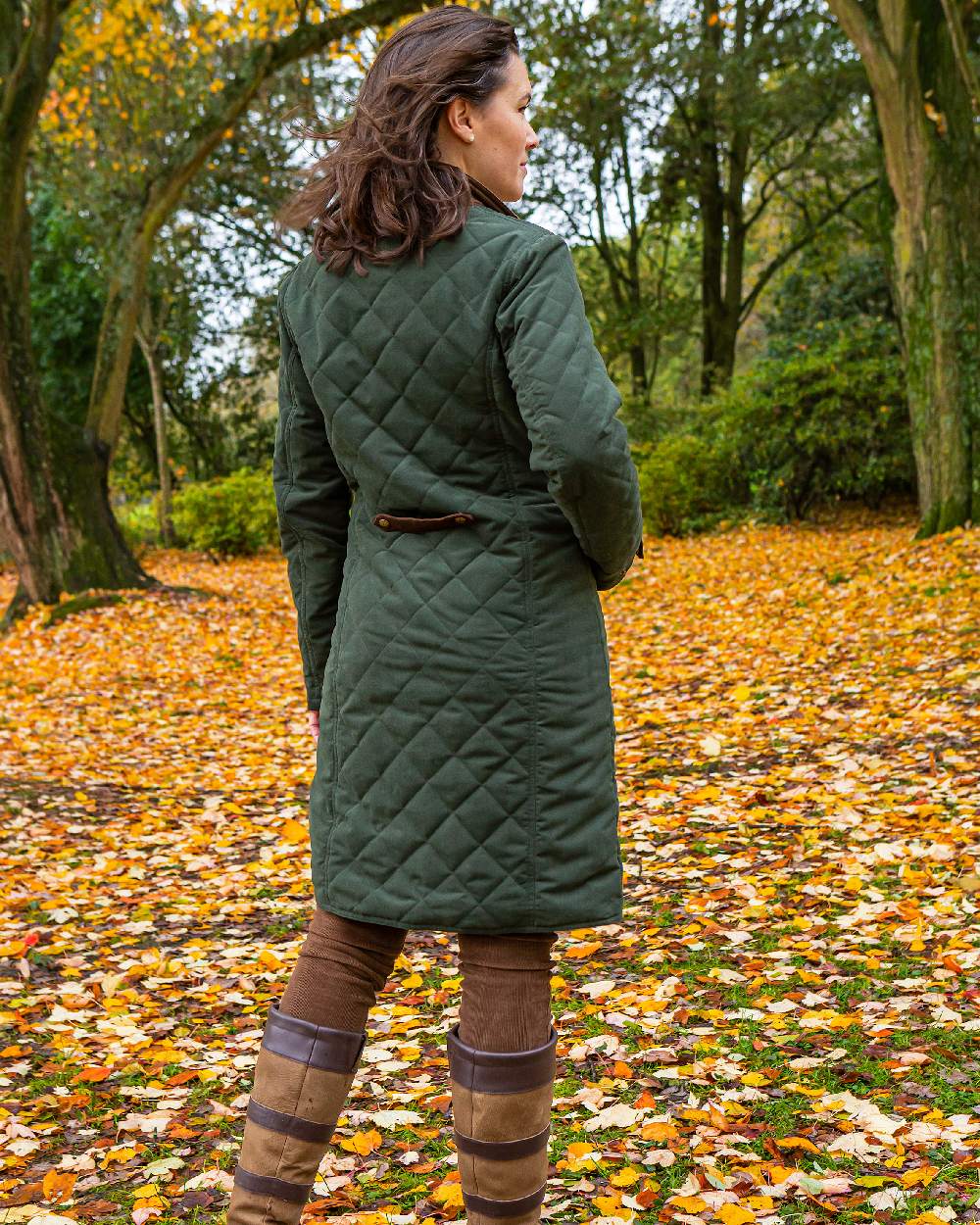 Dark Olive Green Coloured Baleno Womens Audrey Fashionable Quilted Ladies Coat on garden background 