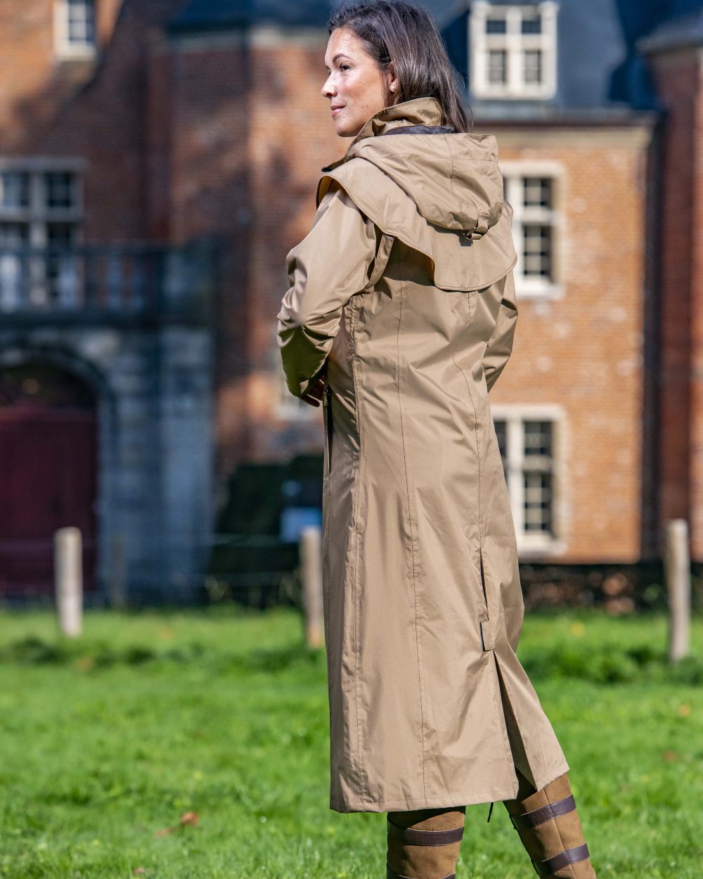 Camel coloured Baleno Oxford Long Waterproof Coat on house background 