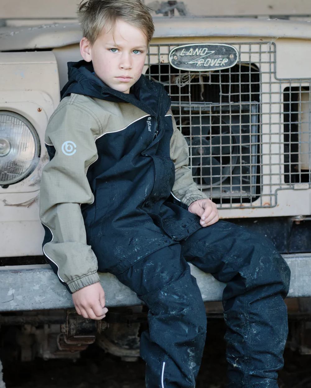 Black Mushroom coloured Betacraft Childrens ISOJNR Jacket on outdoor background 