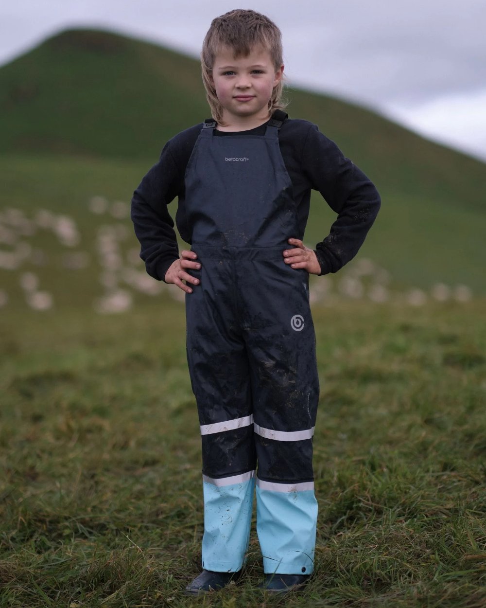 Navy Pale Blue coloured Betacraft Childrens Tuffbak Bib Overtrousers on mountain background 