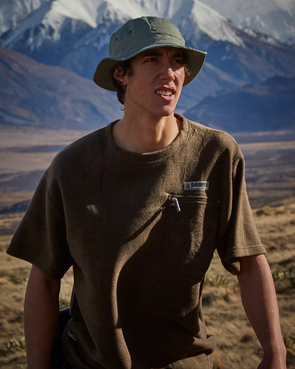 Olive coloured Betacraft Mens Drover Fleece Pack on mountain background 