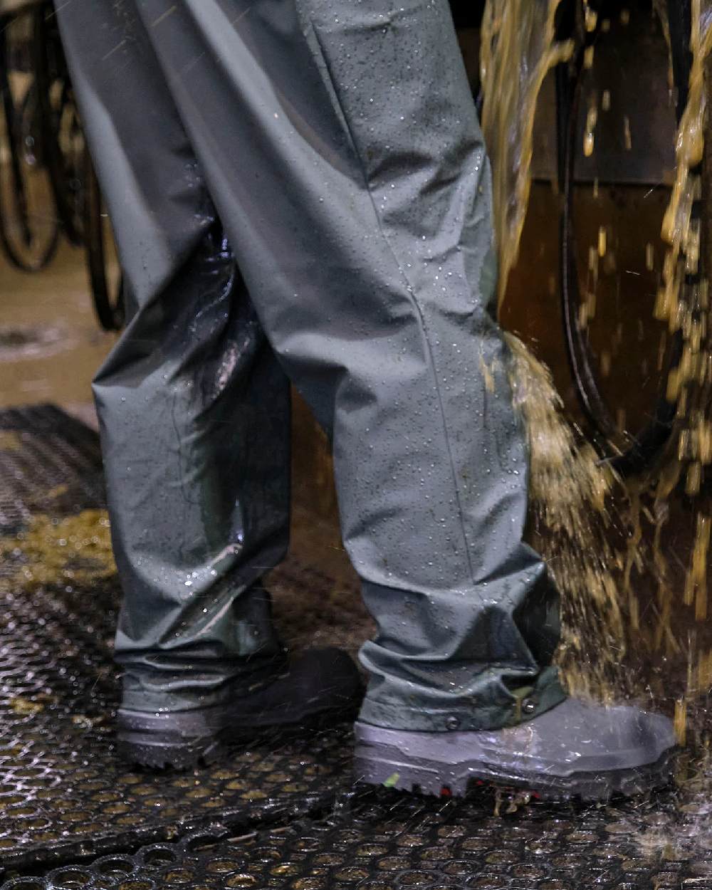 Green coloured Betacraft Mens Technidairy Overtrousers on farm background 