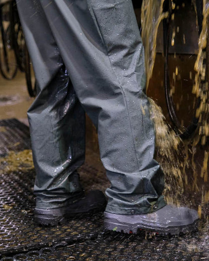 Green coloured Betacraft Mens Technidairy Overtrousers on farm background 