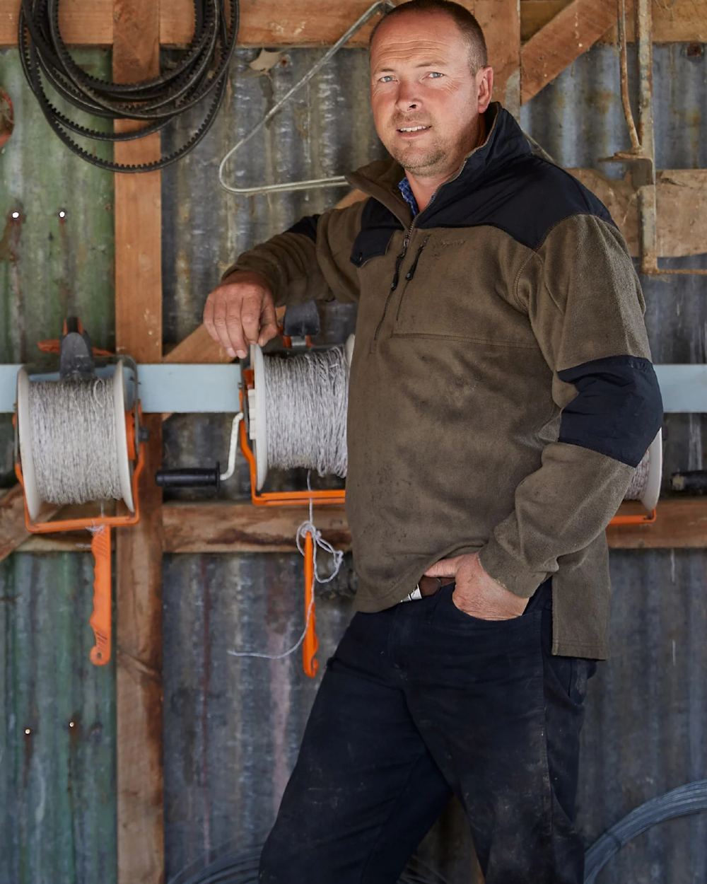 Olive Green coloured Betacraft Quest Fleece Half Zip Sweater on factory background 