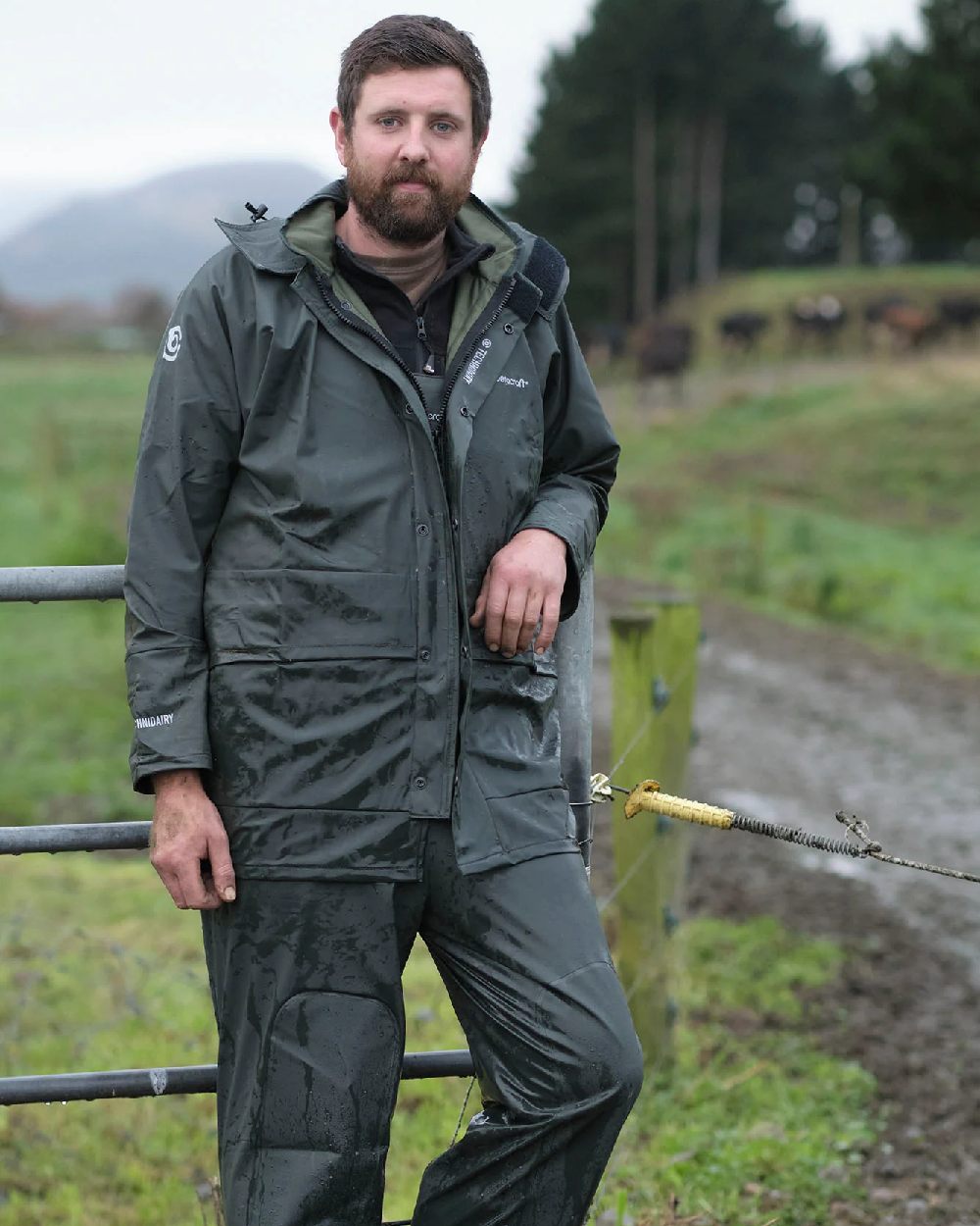 Green coloured Betacraft Technidairy Parka on farm background 