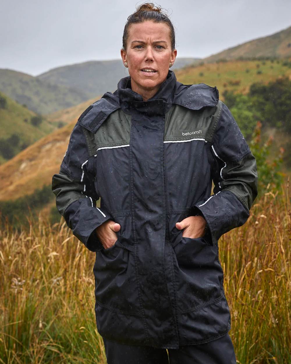 Black Saddle Coloured Betacraft Womens ISO940 Parka on mountain background 