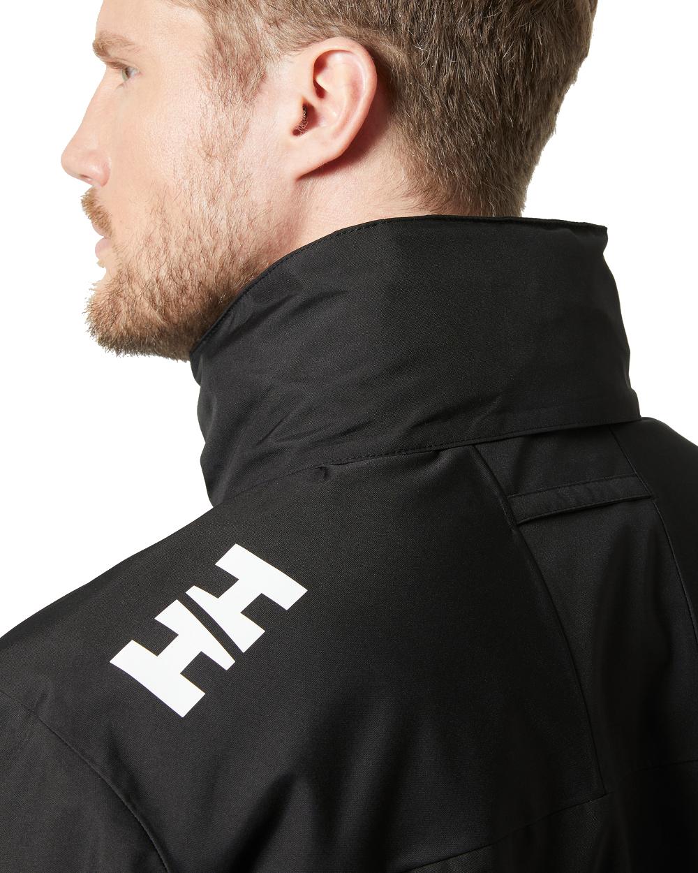 Black coloured Helly Hansen Mens Crew Hooded Jacket 2.0 on grey background 
