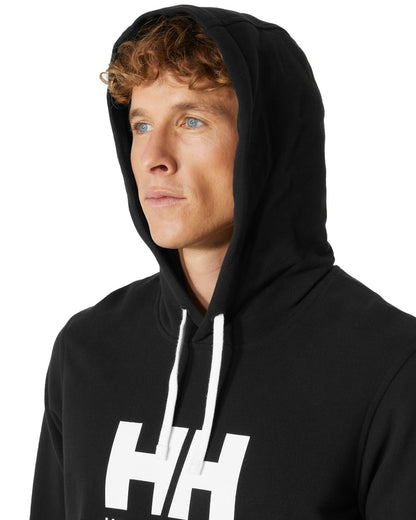 Black Coloured Helly Hansen Mens Logo Hoodie On A White Background 
